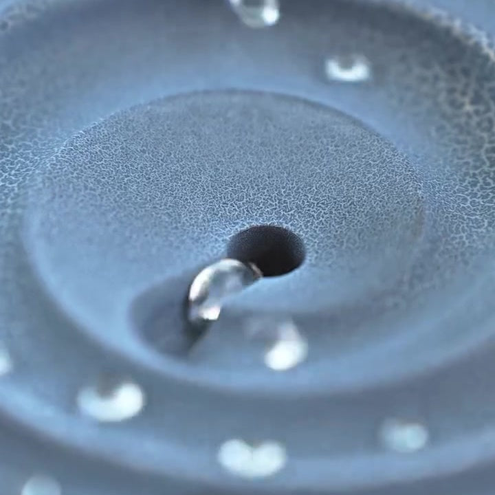 Water droplet falling into center drain